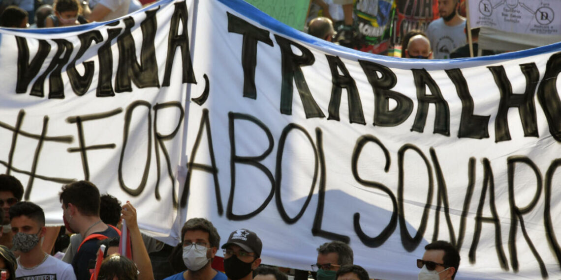 Demonstrators take part in a protest against Brazilian President Jair Bolsonaro in Sao Paulo Brazil on September 12 2021.